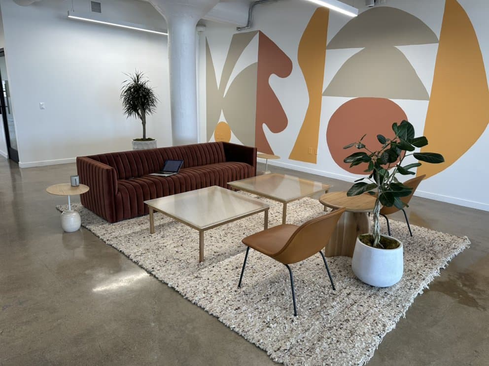 Corporate office lounge with cleaned polished concrete, seating, and rug